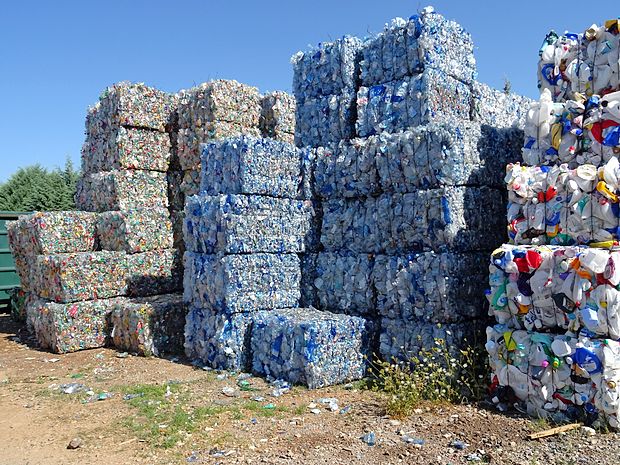 Po barvah ločene plastenke, stisnjene v kockaste bale, čakajo na prevzemnika in reciklažo.